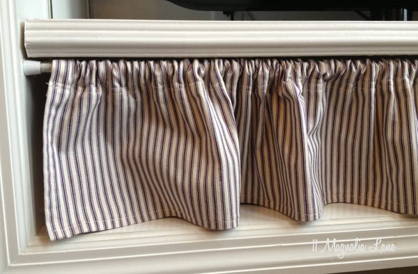 Curtain on tension rod hides TV components at 11 Magnolia Lane