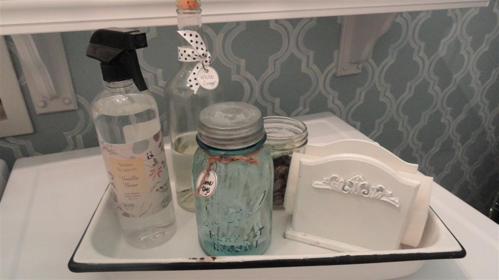Vinegar (for the rinse cycle), ironing spray, change jar, and dryer softener sheets in a napkin holder.