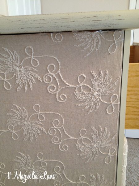 Side of fabric-covered dresser