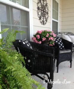 Covered front porch decorated with black, white, and pink