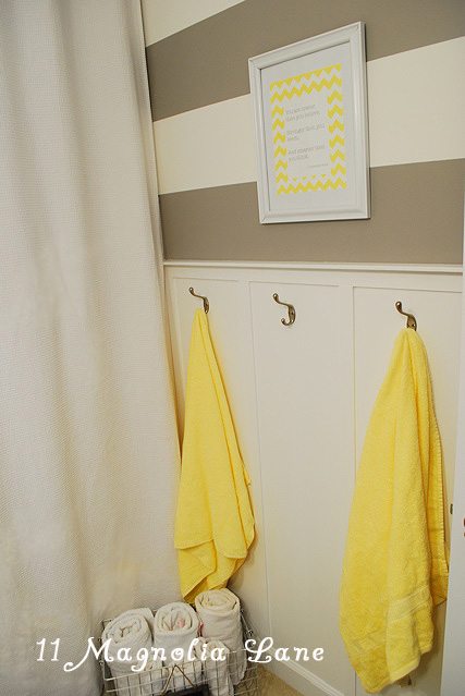 Grey and yellow bathroom with striped walls | 11 Magnolia Lane