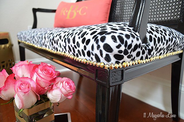 Black cane bench with dalmation print seat and gold nail head trim | 11 Magnolia Lane