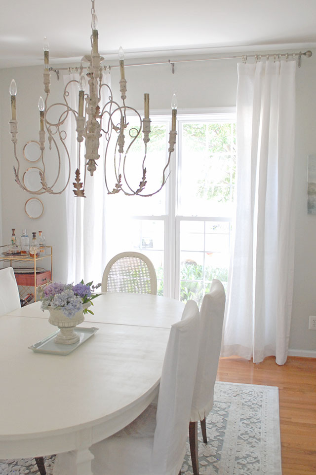 Dining Room with white furniture and gray walls., white linen curtains