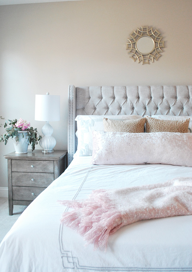 A soothing master bedroom with tones of blush, gray and gold.