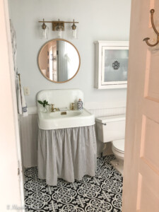 Vintage bathroom redo with black and white clawfoot tub and brass fixtures | 11 Magnolia Lane