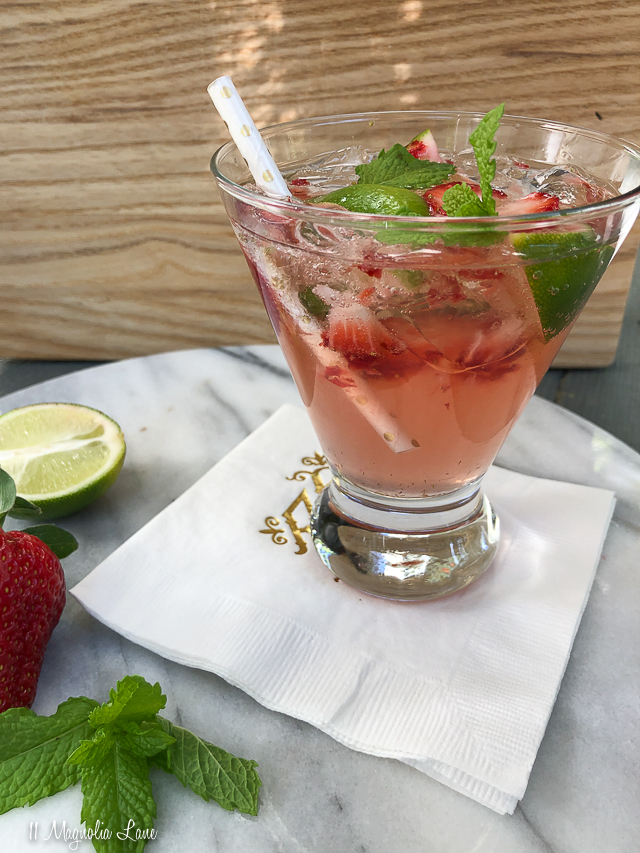 This strawberry mojito cocktail is made with strawberries, lime, mint, simple syrup, rum (white and coconut), and a splash of club soda. Such an easy and refreshing recipe--perfect for your next cocktail hour! | 11 Magnolia Lane